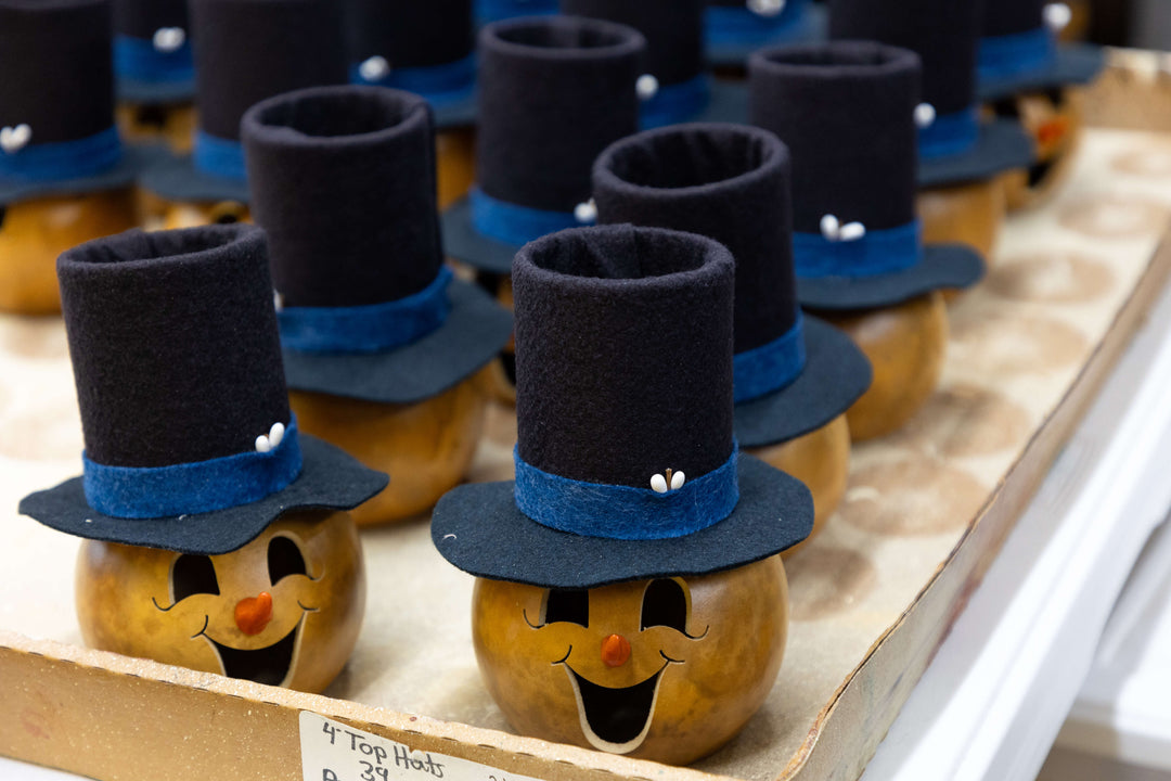 Snowman gourd heads with top hats at Meadowbrooke Gourds.