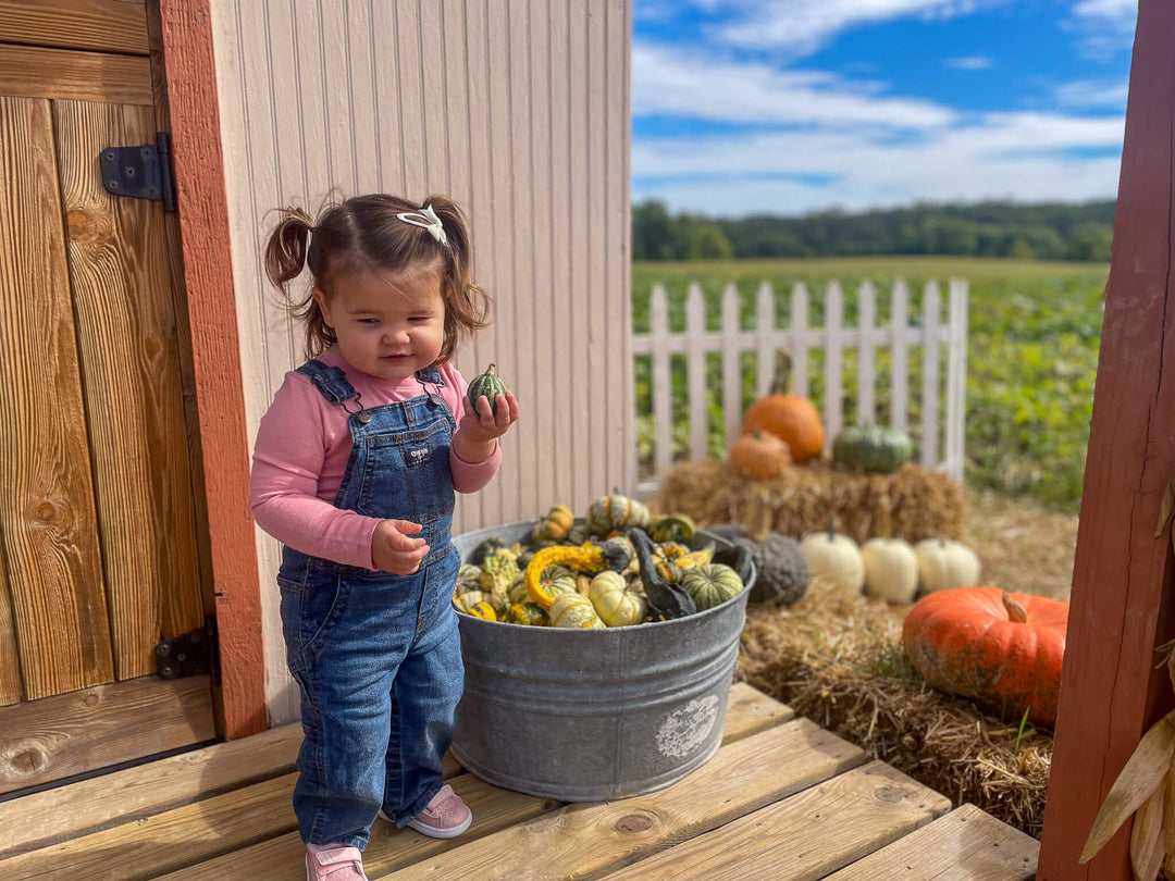 Little girl with decorative gourd bucket