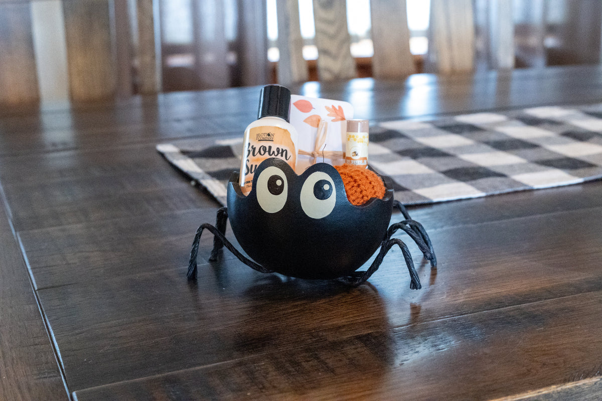 Fall sale limited boo baskets including a small spider gourd candy dish filled with a fall hand lotion, chapstick, note cards, and a knit pumpkin.