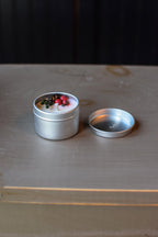 tiny candle in a tin