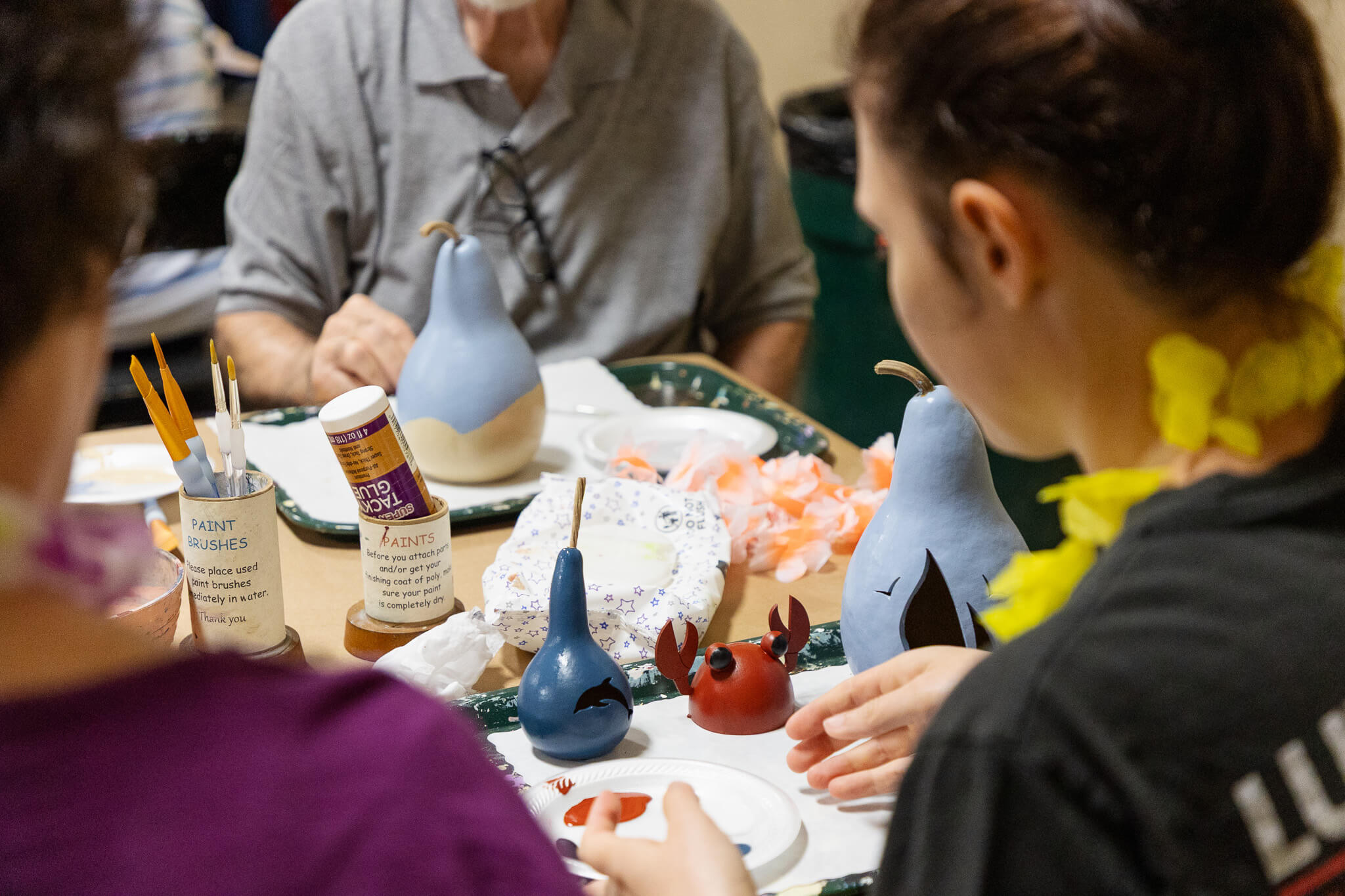 Working on three painted gourd designs at Coastal Themed Gourd at Meadowbrooke Gourds' Coastal Create Your Own Event