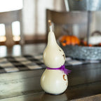 Jake Miniature Winking Ghost with Purple Ribbon side view at Meadowbrooke Gourds.