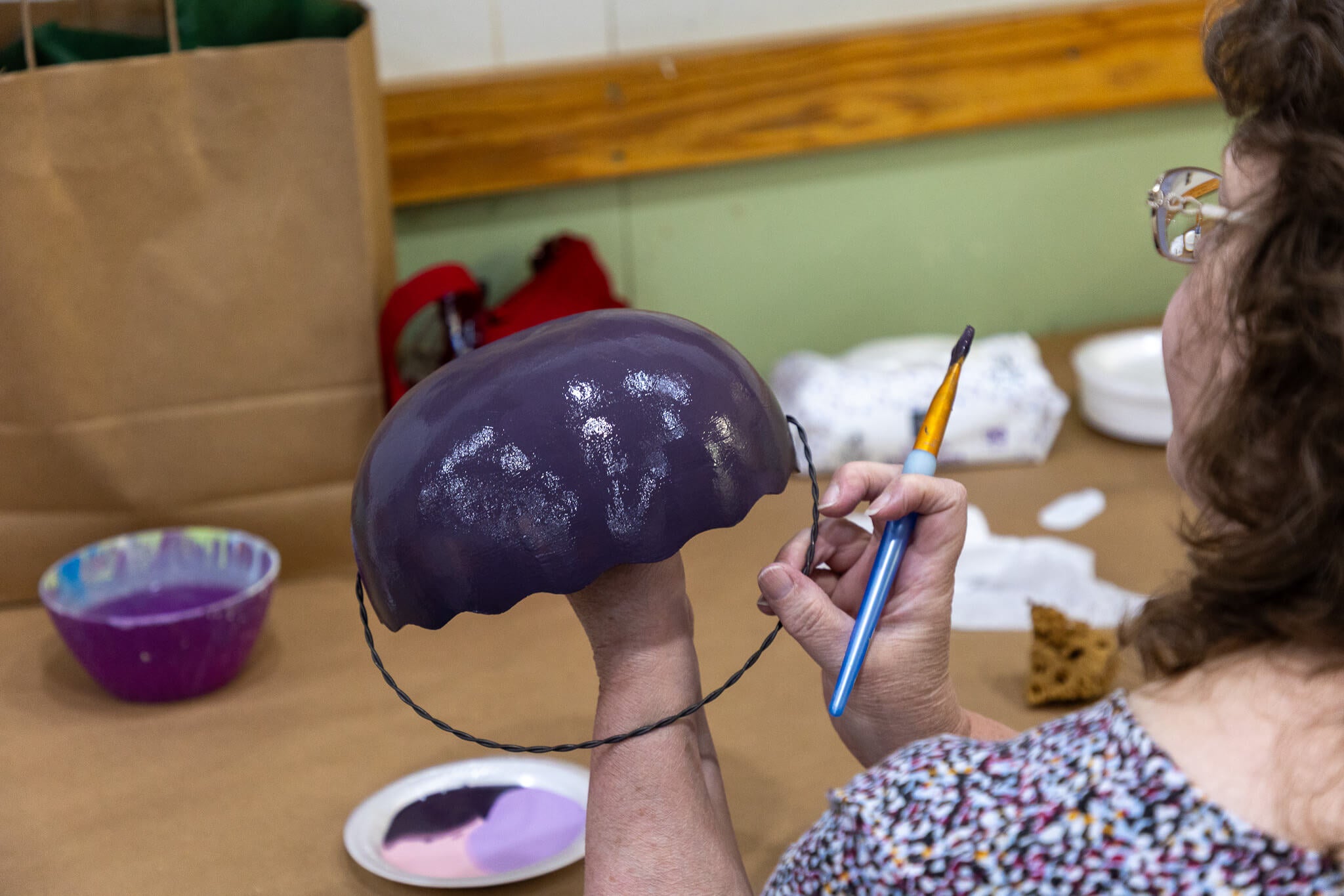 Woman painting gourd easter basket at Meadowbrooke Gourd's Spring Festival.