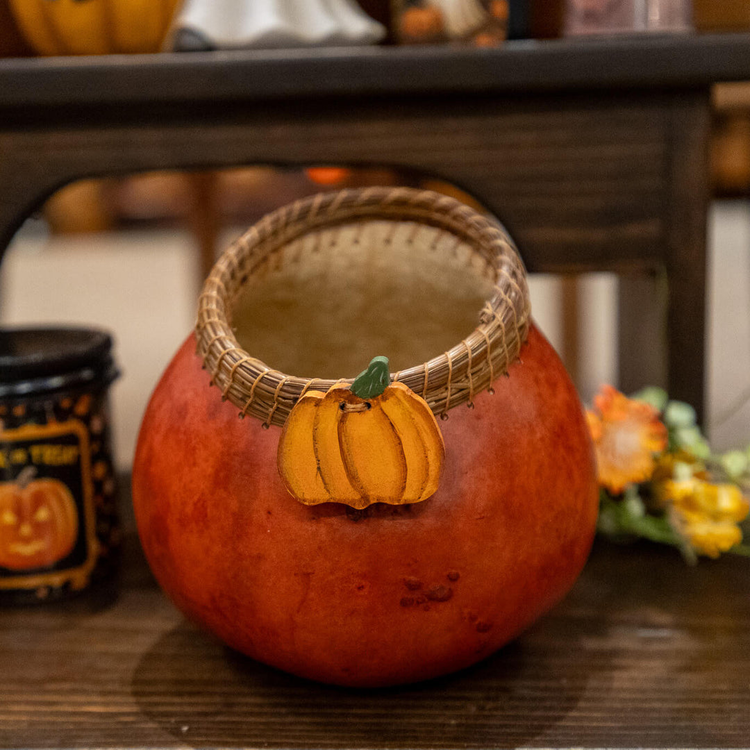 Decorative gourd with a pine needle woven edge, wood pumpkin adornment in a rich rusty color.