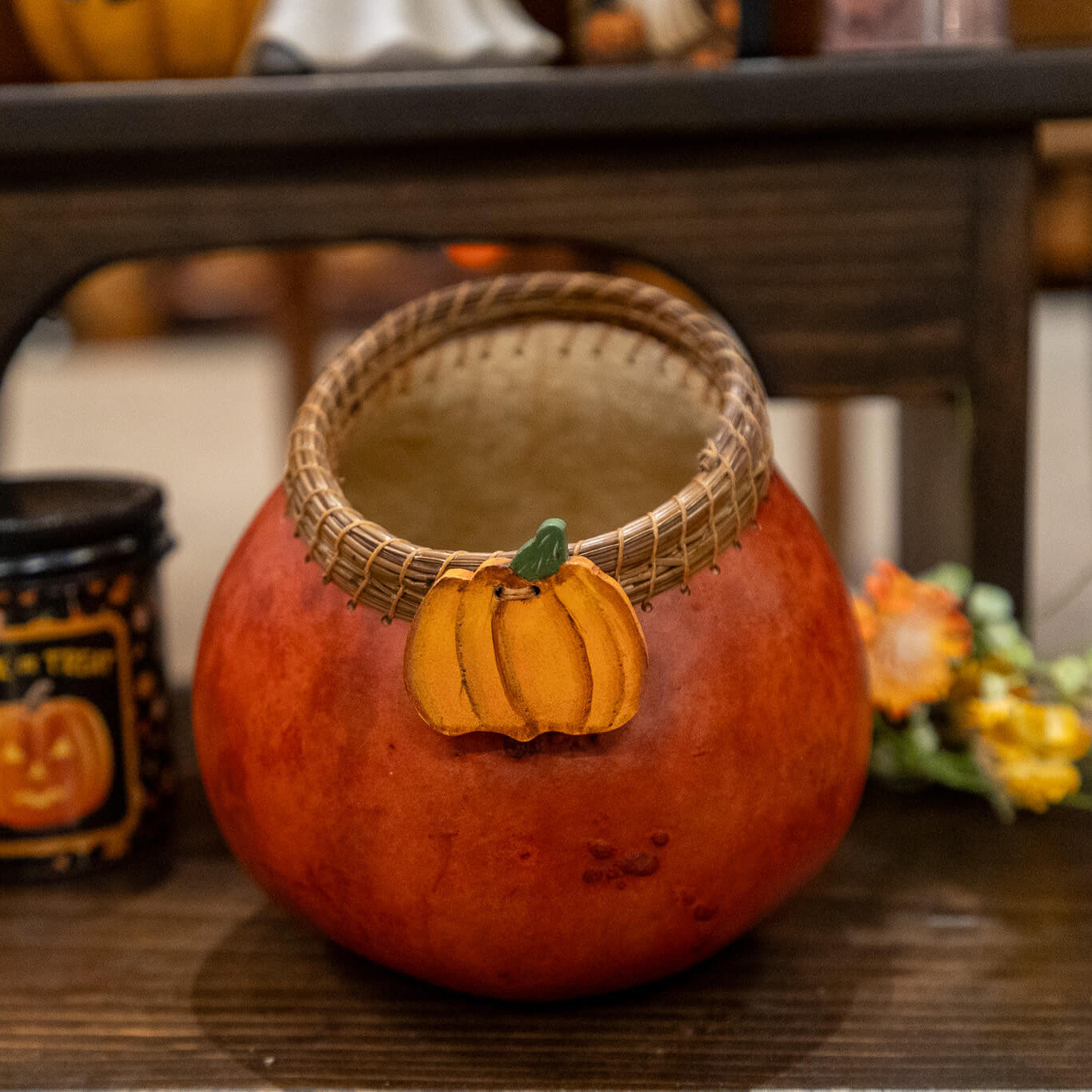 Decorative gourd with a pine needle woven edge, wood pumpkin adornment in a rich rusty color.