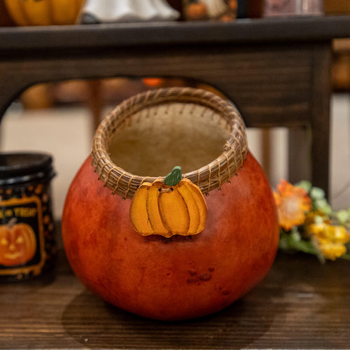 Decorative gourd with a pine needle woven edge, wood pumpkin adornment in a rich rusty color.