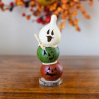 Decorative Halloween gourd with stacked jack-o-lanterns.