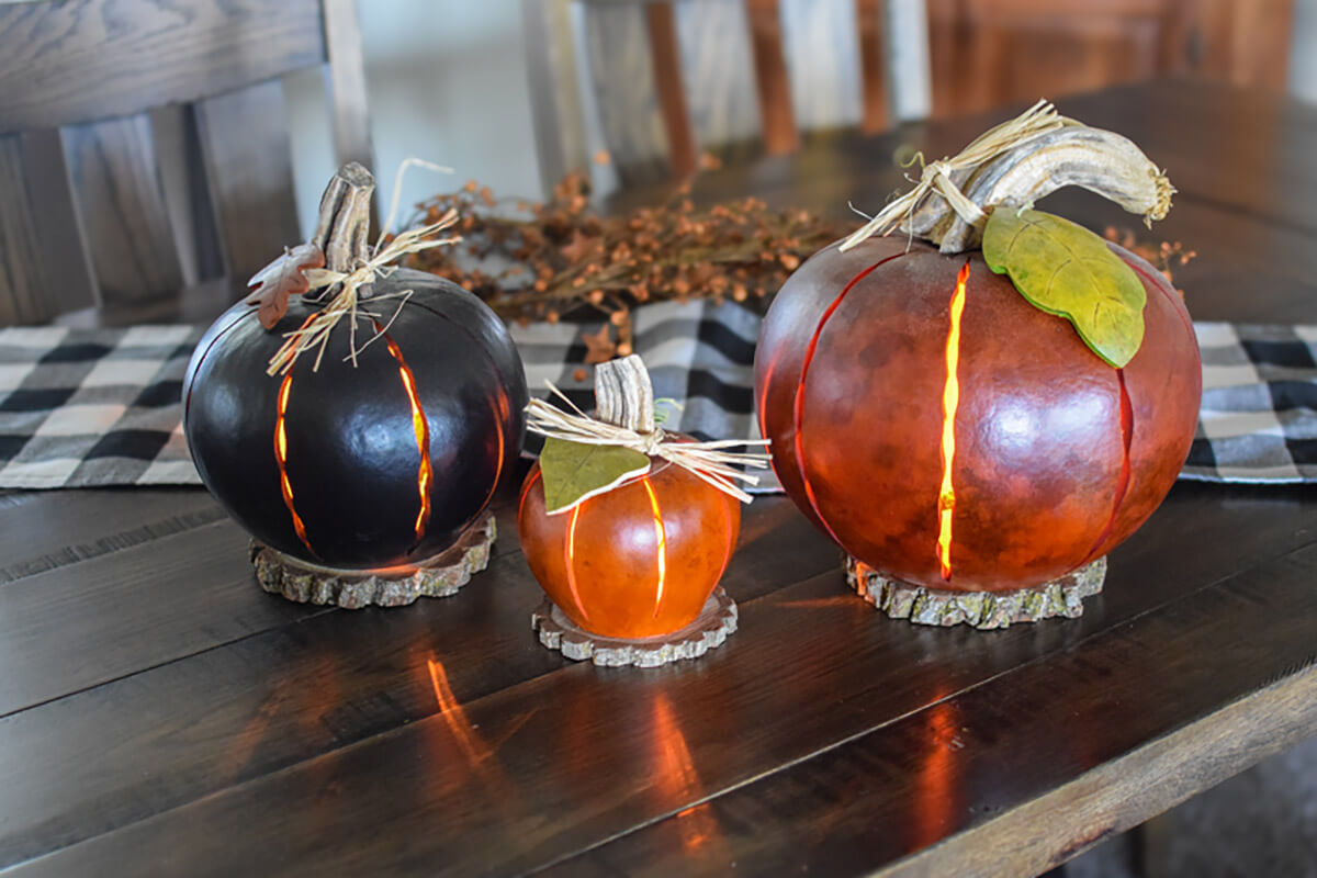 Black small orange and large orange pumpkin luminaries at Meadowbrooke Gourds