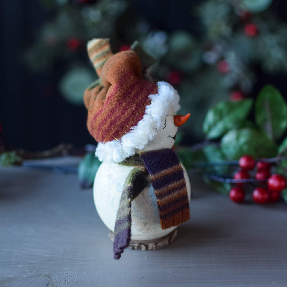 Side view of Tiny Everleigh Snowgirl design, showing her hand-made hat and scarf accessories